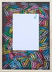 View from above of a Background with colorful paper clips and paper with copy space