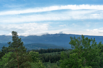 Clouds float over the mountains on a sunny summer day 