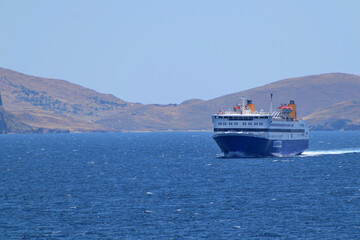 blue ferryboat crossing the blue sea - near Lemnos island, Greece, aegean sea