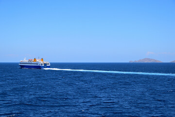 Fototapeta premium blue ferryboat crossing the blue sea - near Lemnos island, Greece, aegean sea