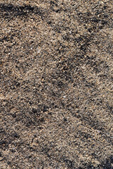 The river sand is coarse-grained. Small pebbles of river sand. Macrophotography of sand.