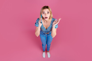 Full body above view portrait of nice young lady speak phone wear top isolated on pink color background