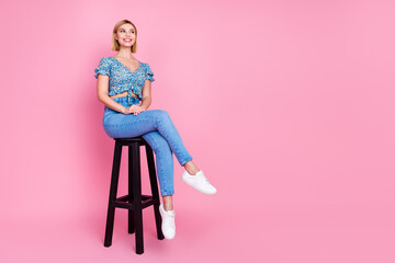 Full body portrait of nice young lady sit stool look empty space think wear top isolated on pink color background