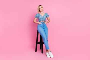 Full body portrait of nice young lady sit stool empty space wear top isolated on pink color background