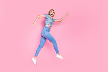 Full length photo of funky lovely lady wear blue blouse jumping high empty space isolated pink color background