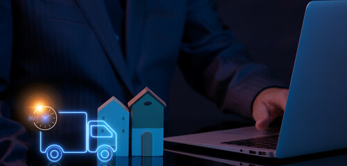 Concept of transportation, distribution, global logistics network, import-export, delivery and shipping, worldwide business. Businessman showing house model with neon line of truck car with clock icon