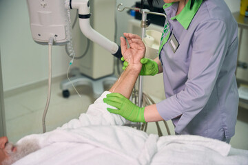 Patient watches a doctor setting up an MRI machine