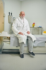 Bearded patient looking at camera in MRI room