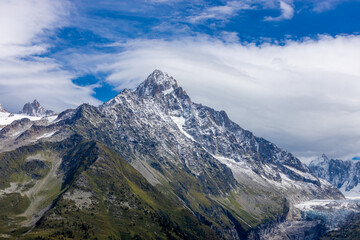 Chamonix Montblanc beautiful alpine mountain summits landscape. Alps mountains with snow and glacier above green valley of Chamonix in France. Alps beautiful scenery in summer