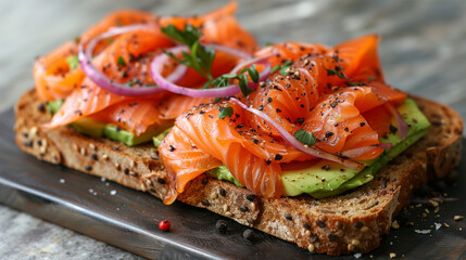 avocado toast with raw smoked salmon on the top and some red onion circle