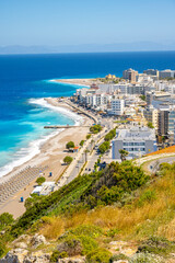 Aegean beach with sunshades in city of Rhodes (Rhodes, Greece)