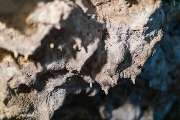 Lime stone stalactites in the cave - mineral formation that hangs from the cave's ceiling