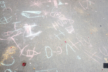 children's drawings on the floor of a school backyard