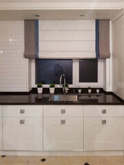 Bright kitchen with roman curtain 