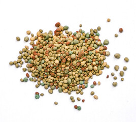Organic-chemical fertilizer pellets on a white background