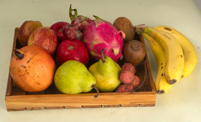 Assortment of fresh organic fruits and vegetables in basket on background, closeup.
