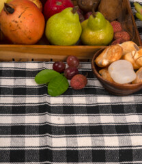 Assortment of fresh organic fruits and vegetables in basket on background, closeup.
