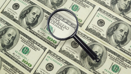 Convertible Note as the business concept. Freely convertible currency US dollar under magnifying glass. Trading and financial risk concept