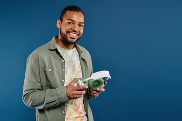 Stylish man confidently holds headphones.