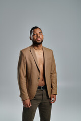 Stylish African American man posing against vibrant backdrop.