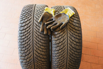 Car wheels, tires and wheels with a shiny disc in a car service center for seasonal replacement or...