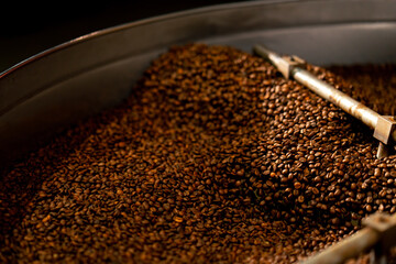 close-up of a coffee roasting factory inside drum roasting stirring coffee
