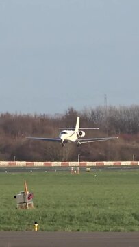 Private Jet Landing at Airport (Private Business Corporate Executive Jet Arriving Arrival Landing Touchdown at Small Regional Airport)