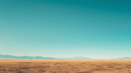 A vast desert landscape with golden sand dunes stretching towards a clear blue sky