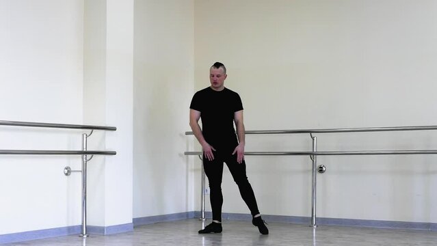 Choreographic plastic movements with hands, male ballerinas. Blet dancer rehearsing in the fitness room. Young handsome dancer training in the dance hall