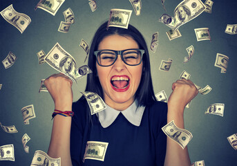 woman exults pumping fists ecstatic celebrates success under money rain