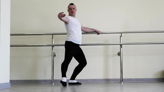 Choreographic plastic movements with hands, male ballerinas. Blet dancer rehearsing in the fitness room. Dancer positions in the dance hall