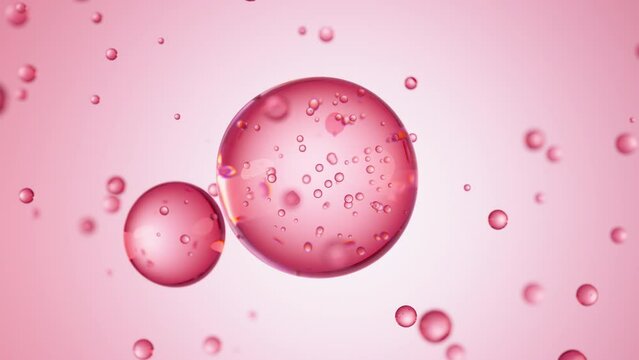 Macro of three drops of red liquid merge into one with bubbles inside. Skin care serum droplets uniting into one. Cosmetics moisturizer fluid concept