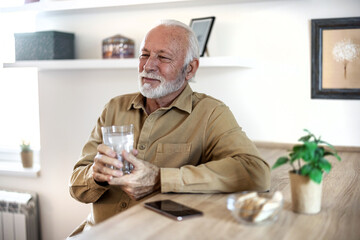 Senior man drink water from glass. Good health, lifestyle.