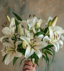 A woman holds a bountiful bouquet of pure white lilies