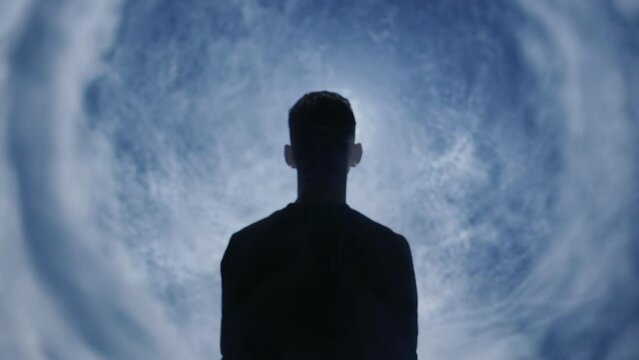 Man in dark room experiencing an out of body experience religious awe transformation