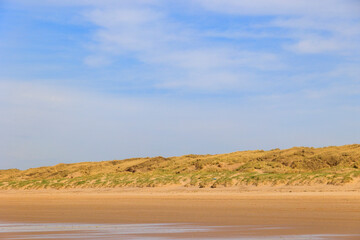 The beach in the Dutch city of Bergen on a sunny day with a blue sky