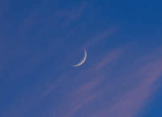 A moon moon in the blue sky. The phase of the moon.