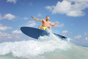 Male surfer riding a surfboard on a wave