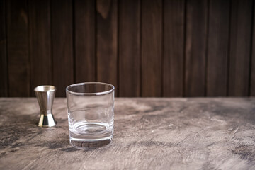 Empty whiskey glass and isolated on wooden background 