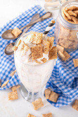 Cinnamon Toast Crunch cold milkshake drink with cinnamon sugar and caramel, glass of iced dairy cocktail with a lot of cinnamon toast cereal mix 