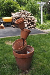 The pottery is stacked one on top of another in the backyard.