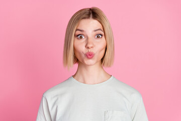 Fototapeta premium Portrait of nice young lady pouted lips kiss wear t-shirt isolated on pink color background