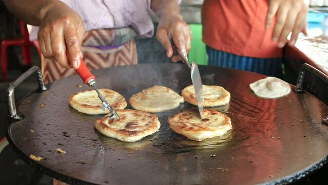 close up man frying roti street food