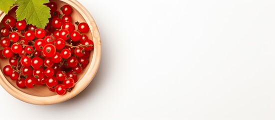 Red currants in wooden bowl on white background top view. Creative banner. Copyspace image