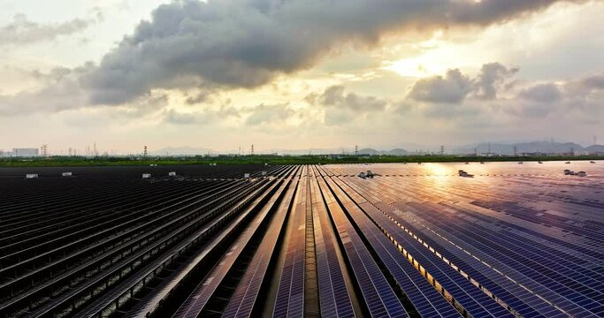Aerial view of solar power plant landscape at sunset. Solar panel power station on the lake.