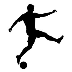 A silhouette of a soccer player kicking a soccer ball on a field