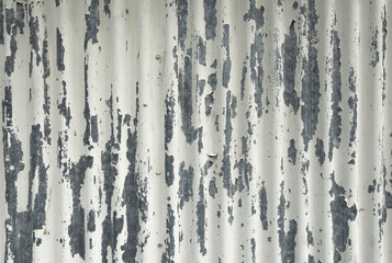 White Peeling Paint On A Corrugated Metal Surface. Painted Weathered Metal With Old Paint. White-Gray Painted Background.