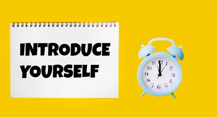 A note with the text Introduce yourself on a yellow background. Self-presentation concept.