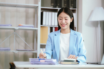 Happy young woman uses laptop computer for virtual meeting Have a video call at home Cheerful Asian woman communicating with colleagues and friends