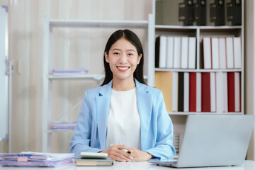 Happy young woman uses laptop computer for virtual meeting Have a video call at home Cheerful Asian woman communicating with colleagues and friends